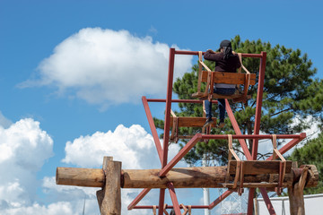 Women ride the wooden Ferris wheel and bright blue sky at Windtime Khao kho , Phetchabun in Thailand.