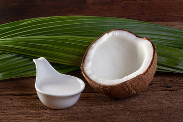 Coconut and coconut milk on wooden background.