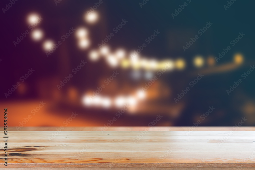 Canvas Prints wooden desk with blurred light on road in city with bokeh abstract background