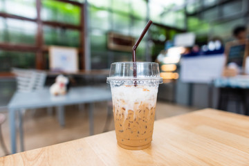 Ice cappuccino coffee in plastic glass with straw ready for drink in the coffee shop