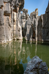 Limestone rock formation reflected in water