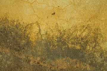 Old yellow gray concrete wall with cracks and damage. rough surface texture.