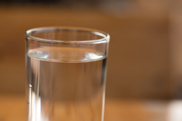 Glass of water on wooden desk