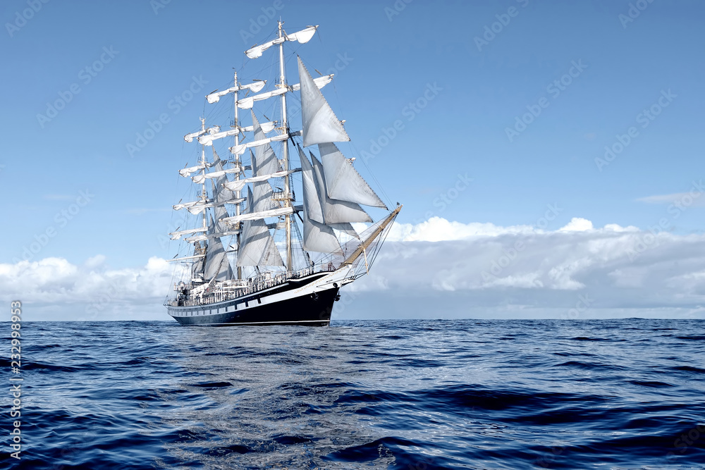 Wall mural sailing ship under white sails at the regatta