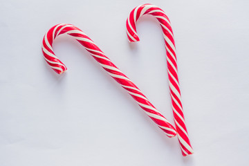 two candy canes on white background. Traditional Christmas candies.