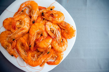 Boiled shrimps on a white plate.