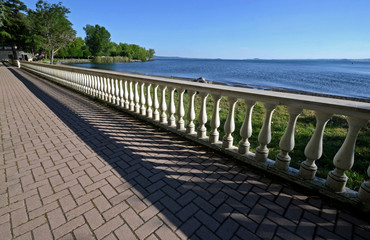 Viterbo, Italy, walkway with balustrade along the shore of the Bolsena lake, on a spring sunny day