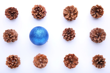 Christmas composition with pine cones and blue christmas ball on white background