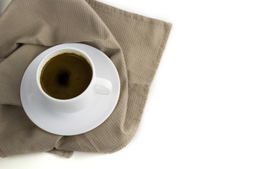 coffee cup on cloth napkin isolated on white background