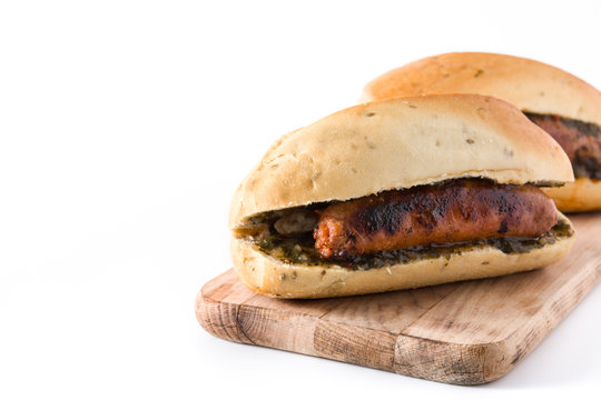Choripan. Traditional Argentina sandwich with chorizo and chimichurri sauce. isolated on white background. Copyspace