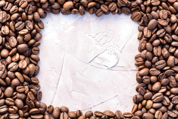 Coffee grains in the bottom of the image on a gently light background