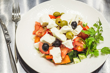 Greek salad with fresh vegetable ingredients in it