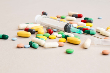 various drugs, tablets and needles, background.