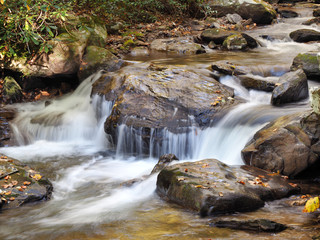 Slow Shutter Speed Image of a Waterfall in a Rocky Stream in the Autumn