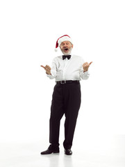 Portrait of Man in Santa Claus Costume - with a Luxurious White Beard, Santa's Hat and a Red Costume at red studio background