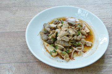 spicy chicken with herb Thai salad on plate