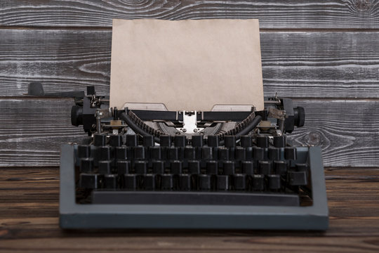 image of retro typewriter on wooden background. writer, journalist.