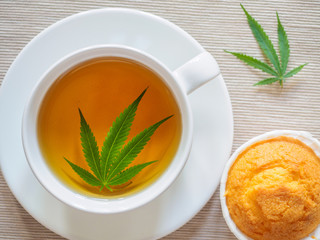 Breakfast with sweet cookies. tea with marijuana. Cannabis leaf is brewed in herbal decoction to treat pain and increase appetite. concept of marijuana use for medicinal purposes.