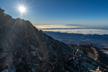 hikers reach the summit of Teide Mountain and enjoy the views from 3718 above sea level, Teide National Park, Tenerife, Canary Islands, Spain