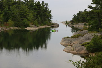 Fototapeta na wymiar lake in forest with kayak on river