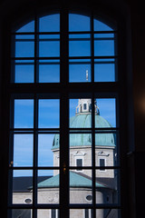 The dome of Salzburg cathedral seen through a window. Austria.