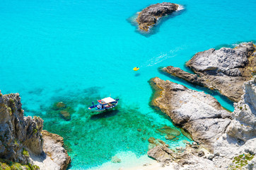 Fishing yacht and rubber boat in Capo Vaticano lagoon, Calabria, Italy