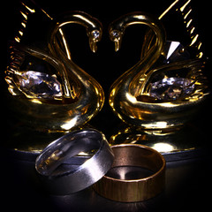 silver and gold ring, a heart-shaped decorative golden swans