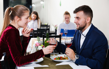 Elegant female and her boyfriend are celebrating date for dinner