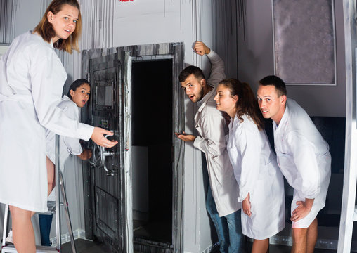 Group of surprised adults wearing lab coats