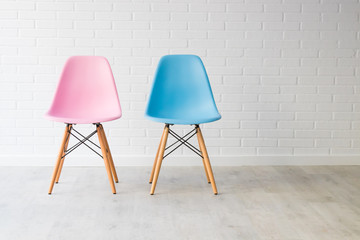pair of chairs in pink and blue, equality concept - obrazy, fototapety, plakaty