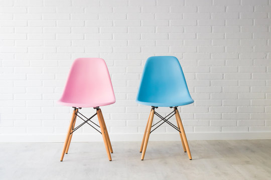 pair of chairs in pink and blue, equality concept