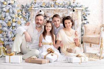 Obraz na płótnie Canvas Portrait of cute happy family celebrating Christmas