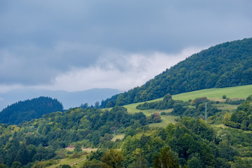 Naklejka na ściany i meble western carpathian Tatra mountain skyline with green fields and forests in foreground