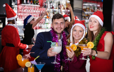 Man with females on corporate new year party in bar