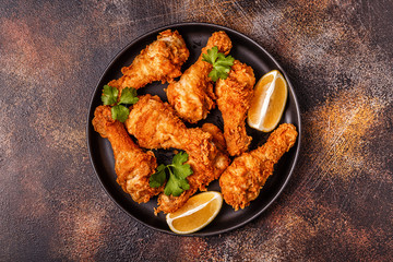Fried chicken legs with lemon and parsley.