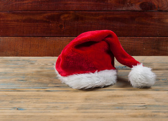 Obraz na płótnie Canvas A Santa Claus hat on a wooden table