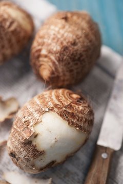 Three Taro roots, one half peeled