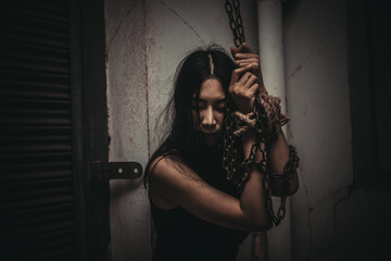 Fototapeta na wymiar Asian hostage woman Bound with rope at night scene,The thieves kidnapped for ransom,thailand people