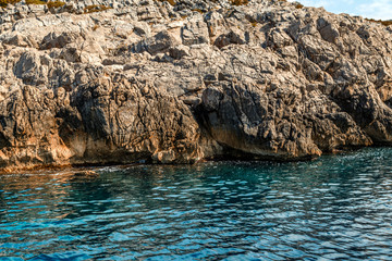 Rocky seashore, limestone cliffs covered with vegetation