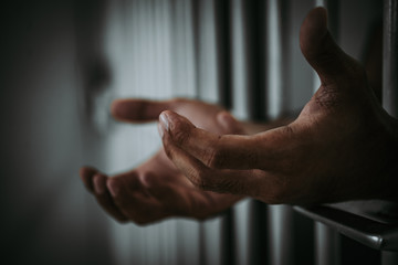 Hands of men desperate to catch the iron prison,prisoner concept,thailand people,Hope to be free.