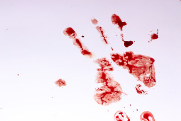 Red imprint of the bloody palm on a white background