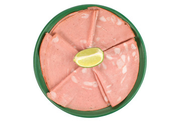 Sliced traditional Brazilian cold cut called mortadela in a green plate seen from above
