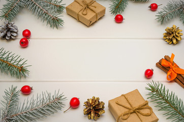 Fototapeta na wymiar Christmas composition. Christmas gifts, fir tree branches on white wooden background. Flat lay, frame.