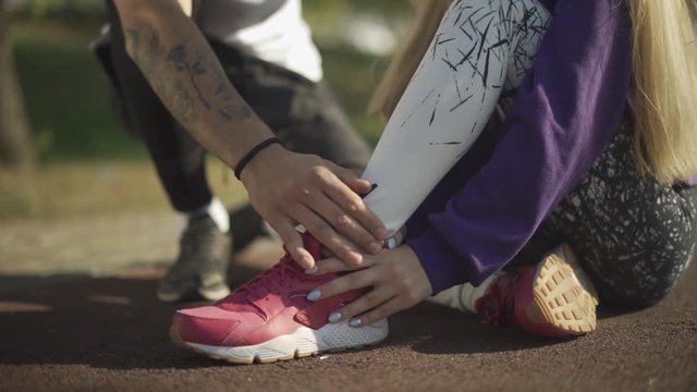 Handsome oung man cares for the girl who sprained his leg