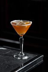 Apple Tini on a bar desk. black background.