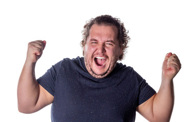Man shouts, lifting his hands up into fists. Excited man celebrating success with hands raised against white background