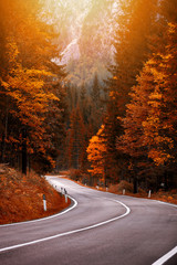 Beautiful autum colors and a mountain road. Path to mountain pass, dolomites, Italy, Europe.