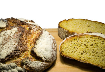 Round corn bread and slices on a cutting board Isolated in a white background