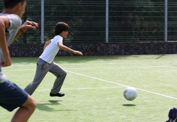 background. handsome guy playing football with friends