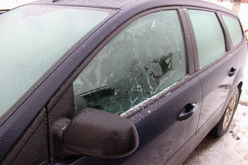 Car with crushed ice frost window windows in winter - driving safety, ice heating, preparation for the trip, front-side view from mirror